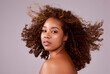 Afro, hair and portrait of black woman in studio with confidence, pride and salon. Natural haircare, curls and hairstyle on female model with growth, style and keratin treatment and pink background