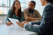 © Drazen - Close up of real estate agent analyzing mortgage contract with  couple during  meeting in office.