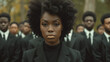 Black Freedom Day. A group of African Americans formally dressed in black strict suits. image focuses on central figure in black turtleneck, rest of participants are slightly out of focus.