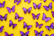 Beautiful Purple Butterflies on Yellow Background with Copy Space in the Middle for Text and Design Elements