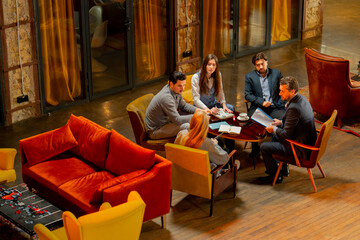 top shot in large beautiful hall office employees sitting on yellow chairs discuss a deal