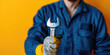 Plumber man holding a adjustable wrench in his hand on colored background with copy space. Banner template for the site of plumbing services.