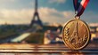 Olympic gold medal with drawing of the Eiffel Tower with the Eiffel Tower in the background