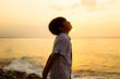 © Djavan Rodriguez - Young Boy Contemplating Life at Sunset by the Sea