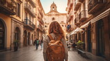 Fototapeta Fototapeta uliczki - A woman walks a narrow street in old European city with a backpack