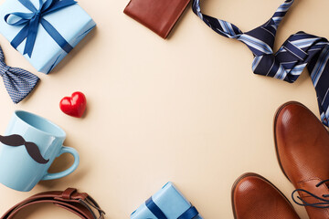 Elegant father's day gift ensemble. Top view of presents and accessories on a beige background with room for advert