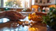 Senior person spilling yellow pills from a medicine bottle on a countertop with sunlight. Elderly care and medication concept.