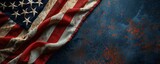Fototapeta  - Aged American flag on textured dark blue background. Patriotic concept.