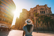 Tourist woman walking in Malaga city at sunset. Summer holiday vacation in Spain