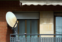 Satellite Dish On An Urban Balcony, Symbolizing The Fusion Of Advanced Technology And Residential Architecture, In A Context Of Modern City Life.
