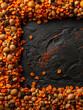 A variety of beans and lentils scattered on a dark background.