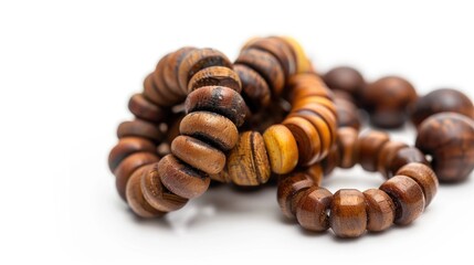 Poster - Wooden beads arranged on a white background, ideal for crafting projects