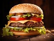 Cheeseburger with beef burger, tomatoes, cheese, pickled cucumber and lettuce on a wooden surface and dark background.