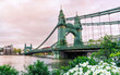 Landscape view of the historical suspension bridge Hammersmith across the River Thames in West London, Great Britain