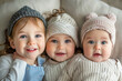 A joyful sister and her baby brother and sister, all dressed in matching outfits.