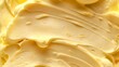 Close up of the creamy texture of yellow butter background.