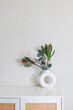 Minimalist home decor. Sandstone donut-shape vase on the dresser