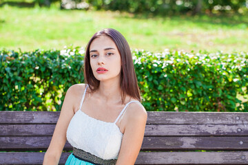 Wall Mural - Portrait of a young beautiful brunette  girl in summer park