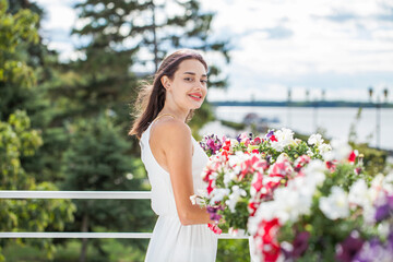 Wall Mural - Young brunette woman in white dress