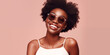 Portrait of Beautiful Young African American Woman in Sunglasses Smiling on Pink Background