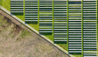Solar panels on field in summer, aerial drone view