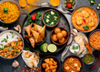 Dishes of indian cuisine. Bowls and plates with indian food on dark background