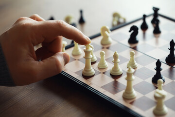 Hand playing game of chess, competition, strategy, battle, play