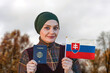 Muslim Woman Holding Passport and Flag of Slovakia
