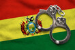 Flag of Bolivia and police handcuffs. Crime and offenses in country Concept

