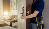 Fototapeta Panele - A technician installs a modern smart door lock on the wood door