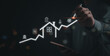 © khunkornStudio - Business professional drawing an upward trend line indicating growth and success strategy