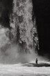 © Cavan Images - Woman traveler at the waterfall Nung Nung. Black and white. Bali