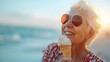 Joyful Senior Woman Savoring Ice Cream on Sunny Beach During Carefree Summer Holiday