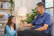 Healthcare concept, Woman caregiver is talking and encourage senior man while visit at home