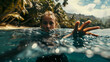 Swimming in the water, blonde woman reaching forward, in tropical water in a swimming costume on a sunny day, blur effect in the backgraund