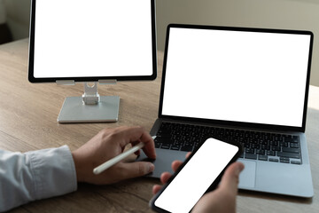 Poster - a businessman in an office uses a tablet to work online desktop computer of the blank screen
