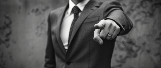 Poster - A man in a suit pointing directly at the camera. Suitable for business concepts