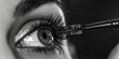 Close up of a woman's eye being applied mascara. Ideal for beauty and makeup industry
