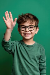 Poster - A young boy wearing glasses waving his hand. Suitable for educational and back to school concepts