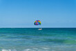 Colorful parasail on the serene blue Caribbean ocean, tied to the boat under a clear sky. Vacations and sports in the tropics in Mexico