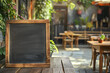 Outdoor Cafe Scene with Empty Blackboard. Empty chalkboard on a wooden table at an outdoor cafe, ideal for advertisement.