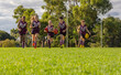 © Austockphoto - low angle image of children running on grass with afl footballs