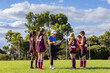 © Austockphoto - female coach with kids football team at training
