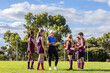© Austockphoto - sports teacher addressing a group of children on football field