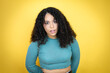 African american woman wearing casual sweater over yellow background afraid and shocked with surprise and amazed expression, fear and excited face.