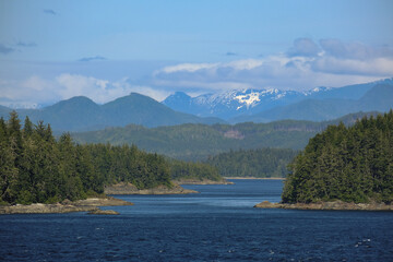 Wall Mural - Panoramic morning or day time landscape nature coastal scenery with beautiful blue sky and dramatic cloudscapes in Alaska Inside Passage glacier mountain range view during cruise