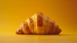   A stack of croissants on a yellow table against a yellow backdrop