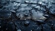   Close-up of water droplets on black surface, blue sky and clouds in background