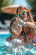 Two little girls having fun blowing bubbles in a pool. Perfect for summer activities or children's leisure concepts