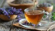 Cup of healthy lavender tea and dry lavender flowers. Bowls of dry medicinal herbs on background